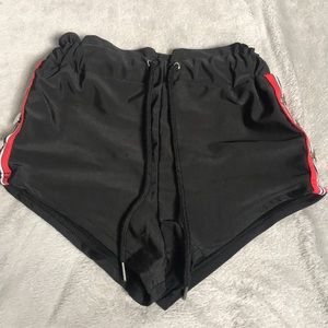 black swim shorts with button/stripe detail